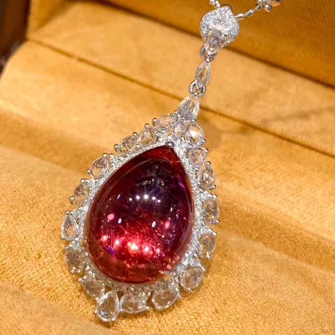 14k Gold 10.7 Ct Natural Tourmaline & Diamond & Sapphire Pendant( Without Chain ): Ref:231051211 // gold content:14k gold // main gemstone:tourmaline // shape:pear // carat weight:10. 7ct // color:red // treatment:natural // // adjacent gemstone 2 : diamond // shape:round // clarity