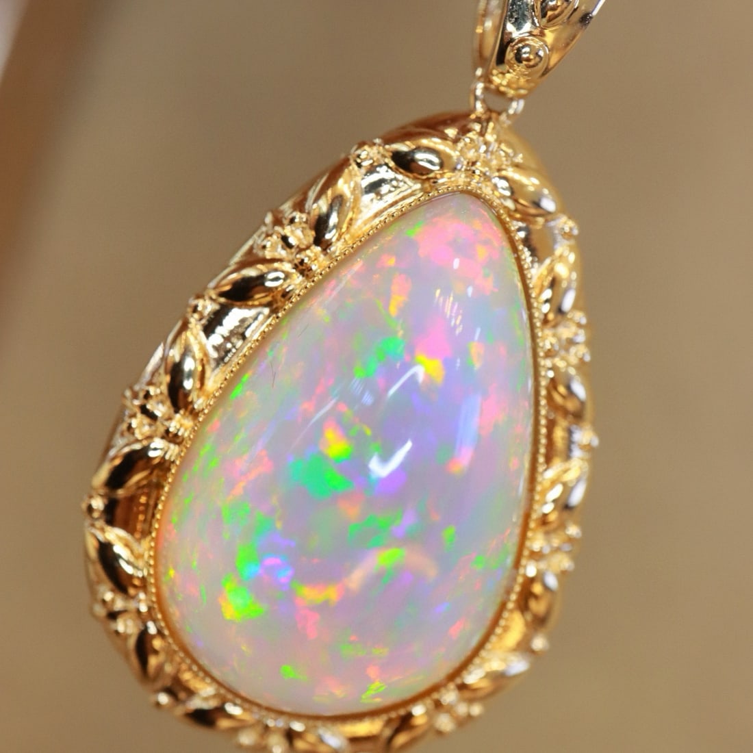 14k Gold 20.46 Ct Natural Opal Pendant( Without Chain ): Ref:231052221 // gold content:14k gold // main gemstone:opal // shape:pear // carat weight:20. 46ct // color:color // treatment:natural // Condition: New Low Estimate: 9500.00 High Estimate: 14000.00