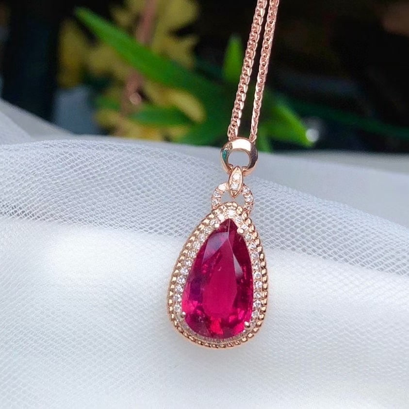 14k Gold 2.83 Ct Natural Tourmaline & Diamond Pendant( Without Chain ): Ref:231052353 // gold content:14k gold // main gemstone:tourmaline // shape:pear // carat weight:2. 83ct // color:red // treatment:natural // // adjacent gemstone 2 : diamond // number of stones:42 //