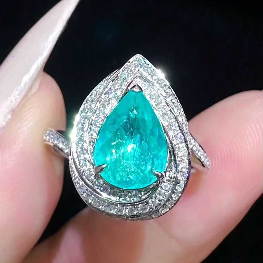 14k Gold 1.44 Ctw Natural Paraiba Tourmaline & Diamond Ring: Ref:231053112 // gold content:14k gold // ring size:7. 25us // // main gemstone:paraiba tourmaline // shape:pear // carat weight:1. 1ct // color:neon blue // treatment:natural // // adjacent gemstone