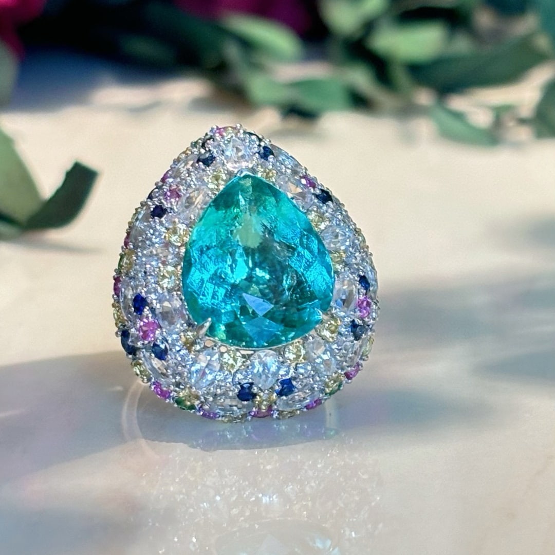 14k Gold 8.9 Ct Natural Paraiba Tourmaline & Sapphire Ring: Ref:231054023 // gold content:14k gold // ring size:7. 25us // // main gemstone:paraiba tourmaline // shape:pear // carat weight:8. 9ct // color:blue // treatment:natural // // adjacent gemstone 2 : s