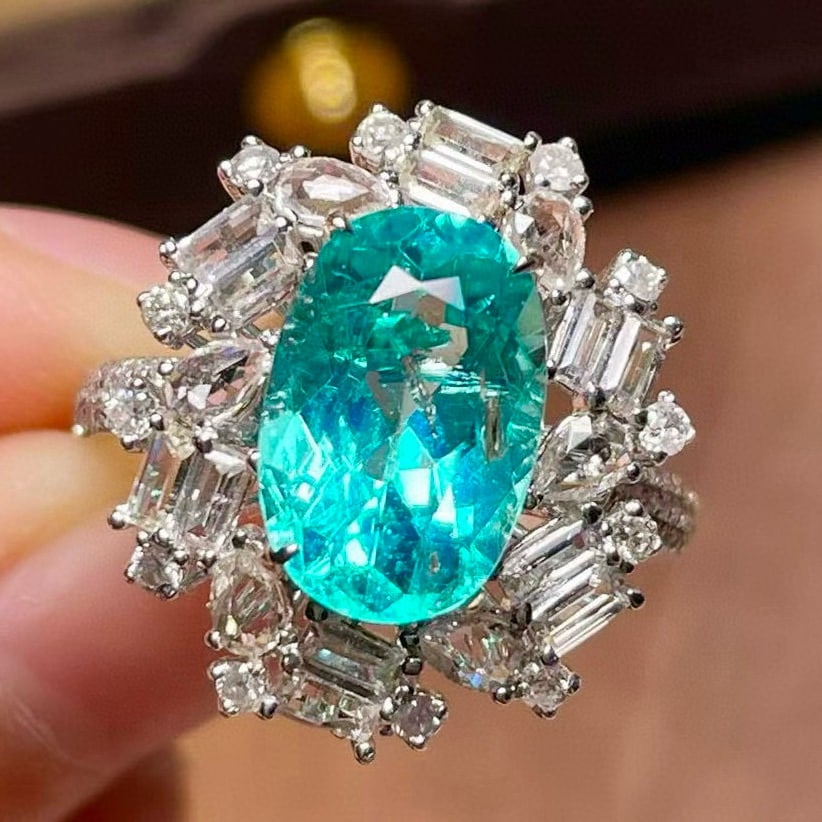 14k Gold 4.50 Ctw Natural Paraiba Tourmaline & Sapphire Ring: Ref:231054370 // gold content:14k gold // ring size:7. 25us // // main gemstone:paraiba tourmaline // shape:oval // carat weight:3. 44ct // color:blue // treatment:natural // // adjacent gemstone 2 :