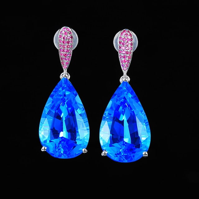 14k Gold 18.51 Ctw Natural Topaz & Ruby Earrings: Ref:231055041 // gold content:14k gold // main gemstone:topaz // shape:pear // carat weight:18. 16ct // color:blue // treatment:natural // // adjacent gemstone 2 : ruby // number of stones:60 // shape