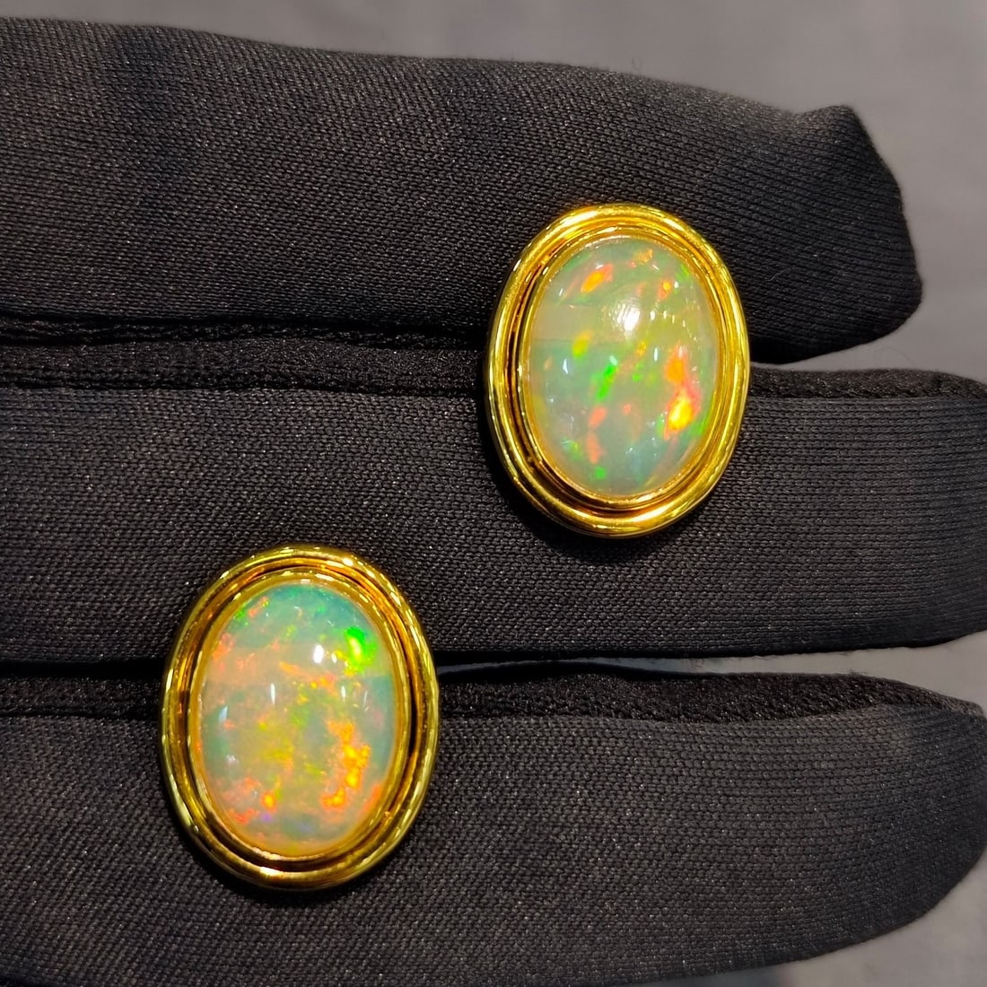 14k Gold 6.43 Ct Natural Opal Earrings: Ref:231056190 // gold content:14k gold // main gemstone:opal // shape:oval // carat weight:6. 43ct // color:color // treatment:natural // Condition: New Low Estimate: 3700.00 High Estimate: 5600.00