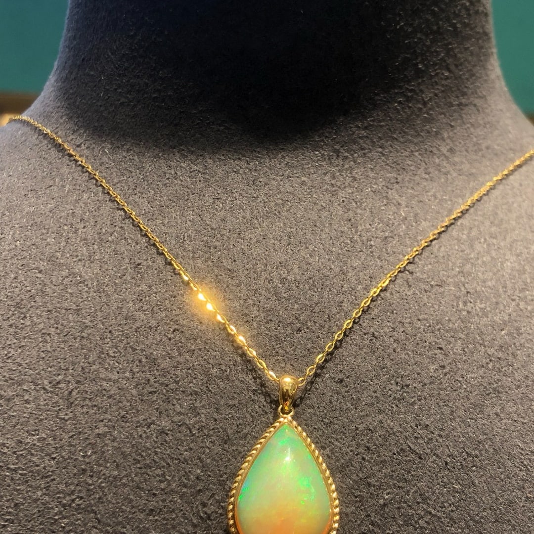 14k Gold 7.38 Ct Natural Opal Necklace: Ref:231056214 // gold content:14k gold // main gemstone:opal // shape:pear // carat weight:7. 38ct // color:color // treatment:natural // Condition: New Low Estimate: 15000.00 High Estimate: 22000.00