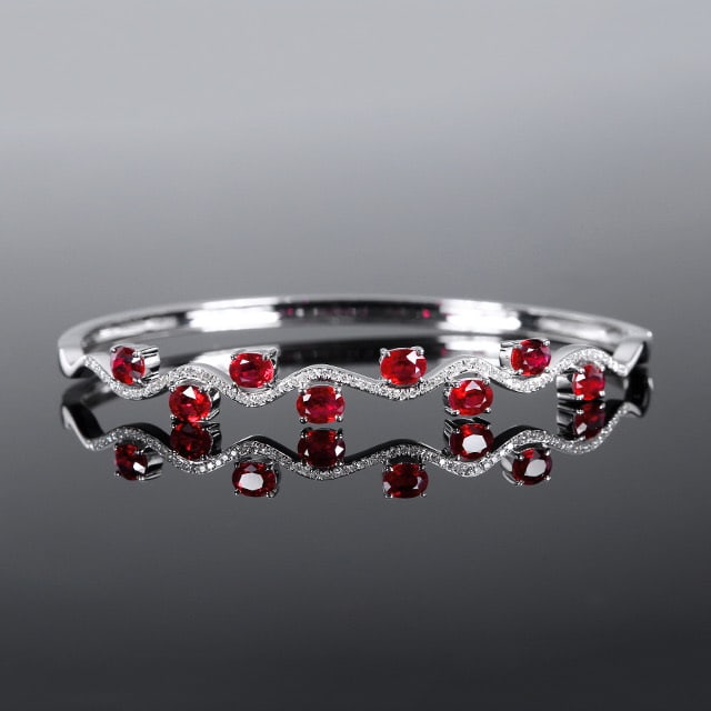 14k Gold 2.48 Ctw Natural Ruby & Diamond Bangle: Ref:231061027 // gold content:14k gold // main gemstone:ruby // shape:oval // carat weight:2. 27ct // color:red // treatment:natural // // adjacent gemstone 2 : diamond // number of stones:70 //
