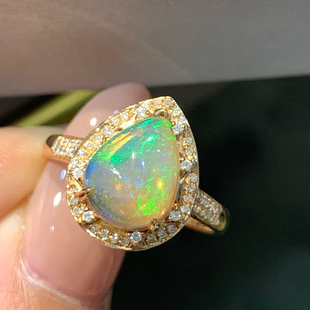14k Gold 1.74 Ctw Natural Opal & Diamond Ring: Ref:231065211 // gold content:14k gold // ring size:7. 25us // // main gemstone:opal // shape:pear // carat weight:1. 19ct // color:color // treatment:natural // // adjacent gemstone 2 : diamond //
