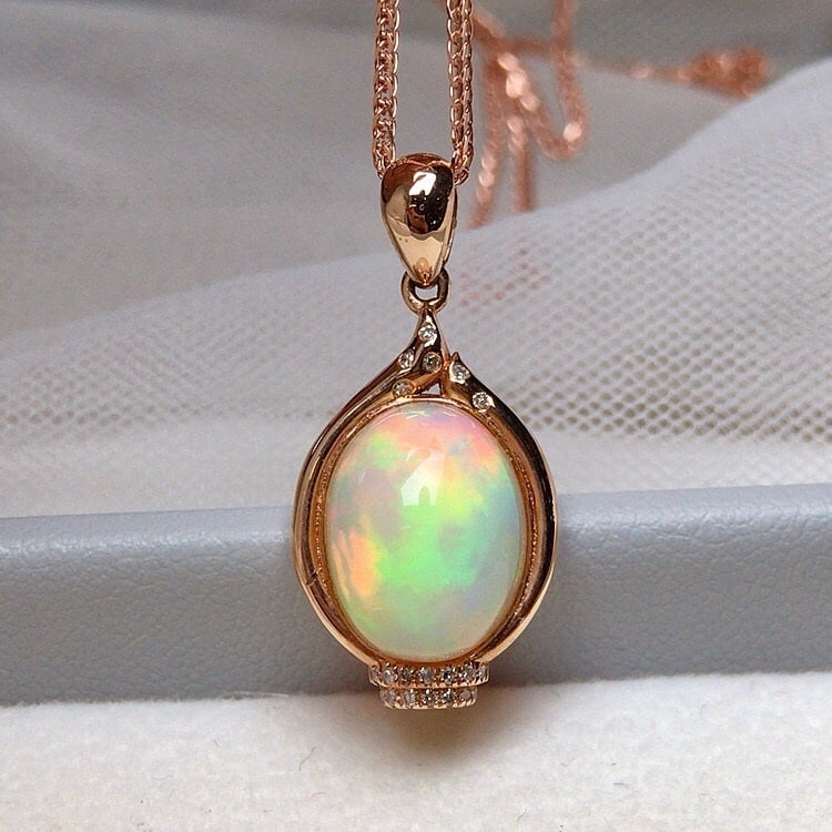 14k Gold 3.50 Ct Natural Opal & Diamond Pendant( Without Chain ): Ref:231067112 // gold content:14k gold // main gemstone:opal // shape:oval // carat weight:3. 50ct // color:color // treatment:natural // // adjacent gemstone 2 : diamond // number of stones:20 // sha