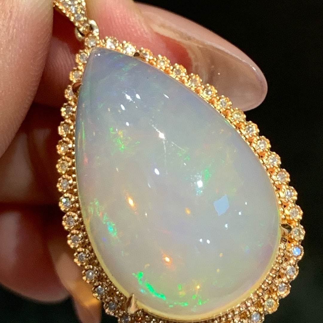 14k Gold 17.86 Ctw Natural Opal & Diamond Pendant( Without Chain ): Ref:231067150 // gold content:14k gold // main gemstone:opal // shape:pear // carat weight:17. 23ct // color:white // treatment:natural // // adjacent gemstone 2 : diamond // shape:round // carat