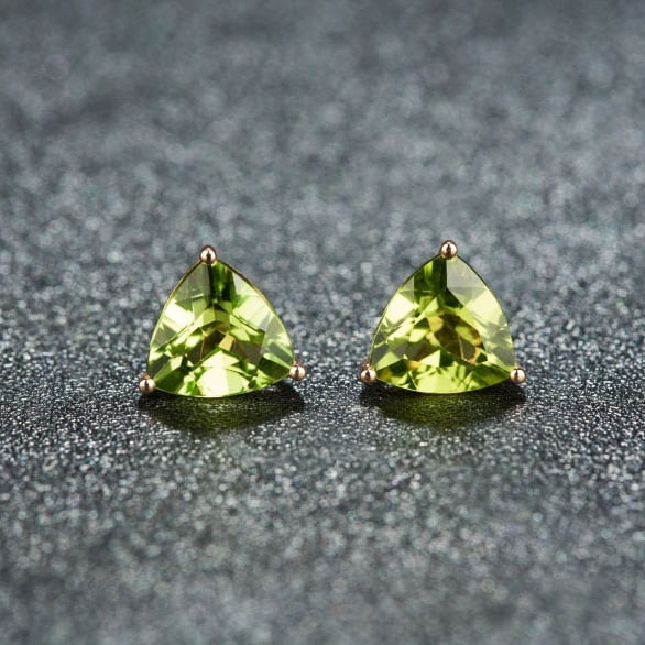14k Gold 3.11 Ct Natural Peridot Earrings: Ref:231068073 // gold content:14k gold // main gemstone:peridot // shape:triangle // carat weight:3. 11ct // color:green // treatment:natural // Condition: New Low Estimate: 1200.00 High Estimate: