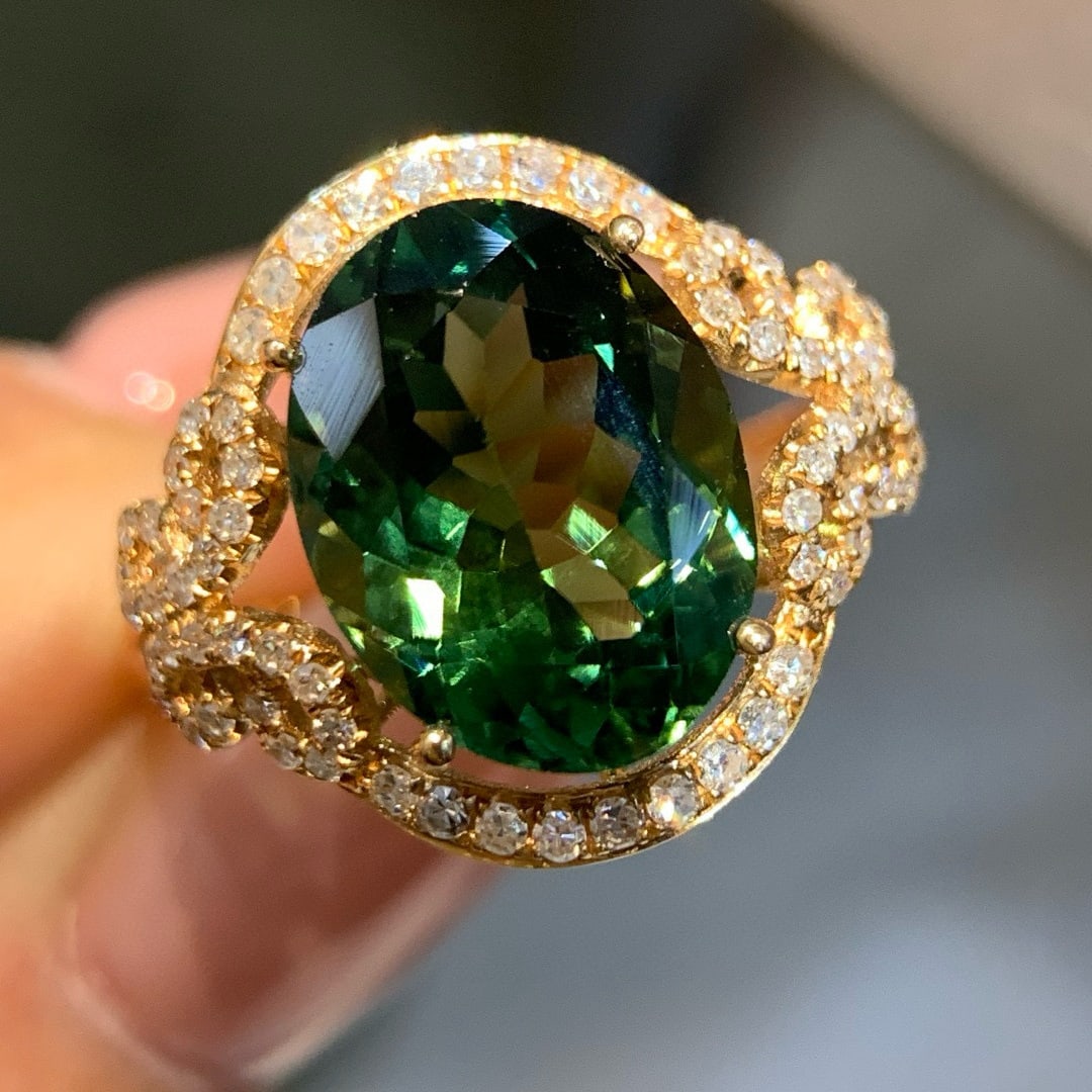 14k Gold 7.02 Ctw Natural Tourmaline & Diamond Ring: Ref:231070428 // gold content:14k gold // ring size:7. 25us // // main gemstone:tourmaline // shape:oval // carat weight:6. 3ct // color:green // treatment:natural // // adjacent gemstone 2 : diamond 