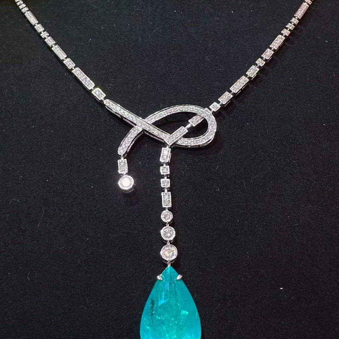 14k Gold 7.25 Ctw Natural Paraiba Tourmaline & Diamond Necklace: Ref:231071011 // gold content:14k gold // main gemstone:paraiba tourmaline // shape:pear // carat weight:6. 49ct // color:blue // treatment:natural // // adjacent gemstone 2 : diamond // shape:round