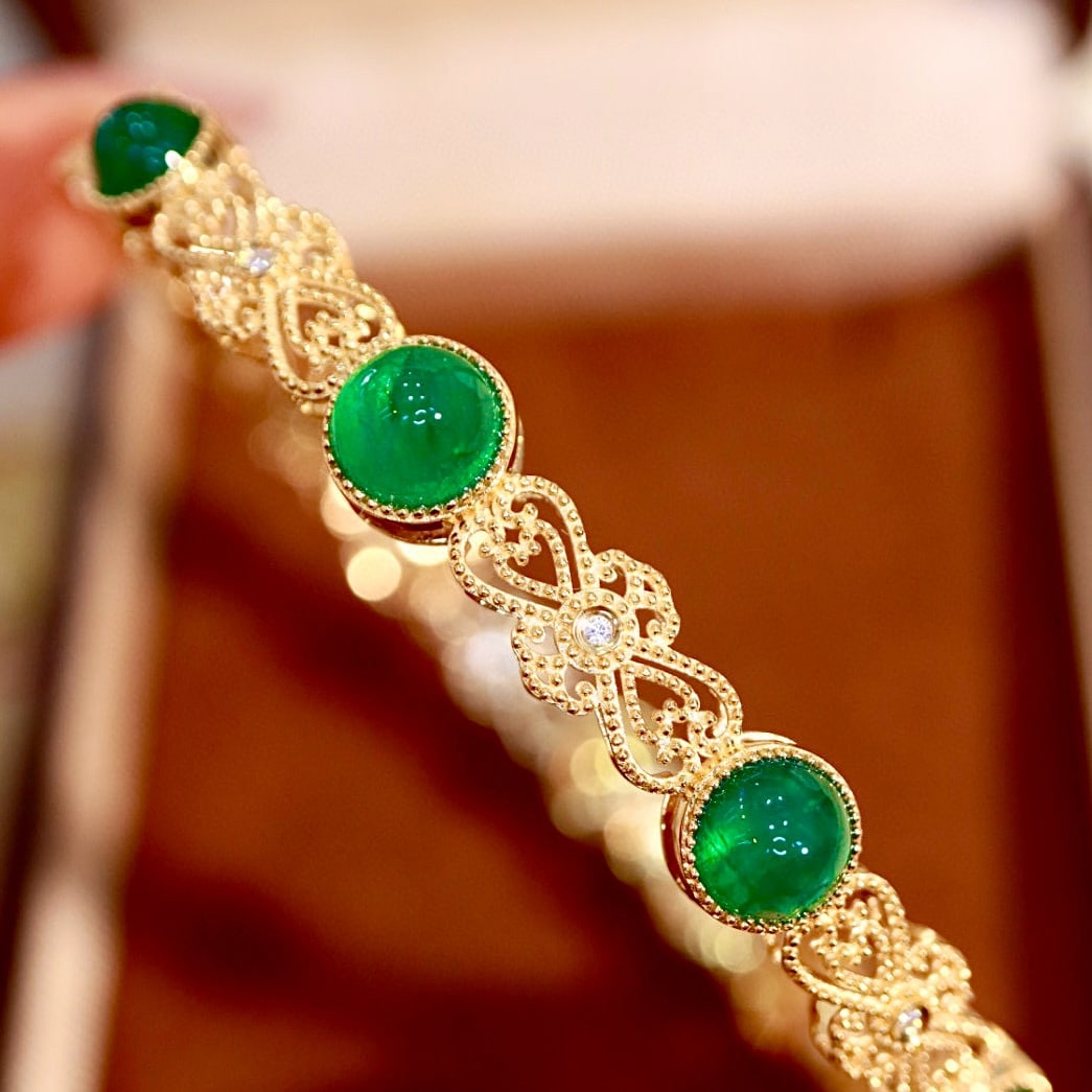 14k Gold 8.24 Ctw Vivid Green Natural Emerald & Diamond Bangle: Ref:231072288 // gold content:14k gold // main gemstone:emerald // shape:round // carat weight:8. 2ct // color:vivid green // treatment:natural // cut grade:g // // adjacent gemstone 2 : diamond // sh