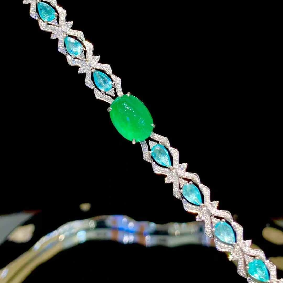 14k Gold 9.1 Ctw Natural Emerald & Paraiba Tourmaline Bracelet: Ref:231073046 // gold content:14k gold // main gemstone:emerald // shape:oval // carat weight:5. 6ct // color:green // treatment:natural // // adjacent gemstone 2 : paraiba tourmaline // shape:pear //