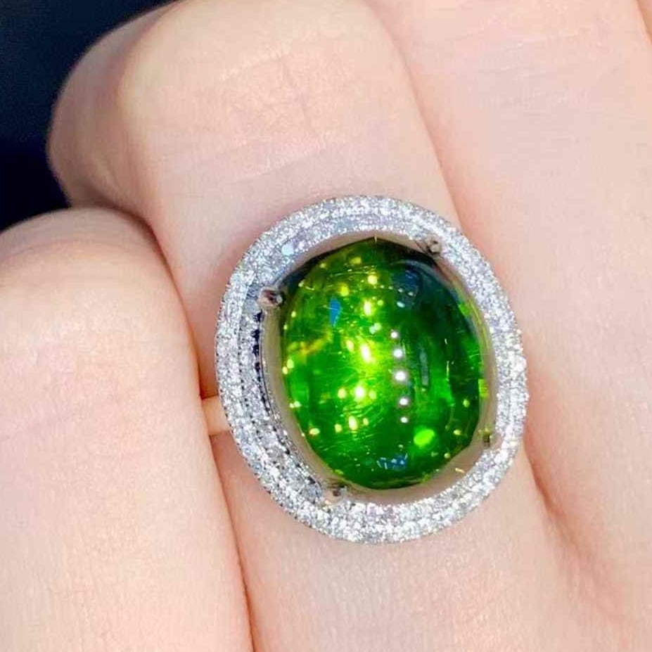14k Gold 8.5 Ct Natural Tourmaline & Diamond Ring: Ref:231073086 // gold content:14k gold // ring size:7. 25us // // main gemstone:tourmaline // shape:oval // carat weight:8. 5ct // color:green // treatment:natural // // adjacent gemstone 2 : diamond
