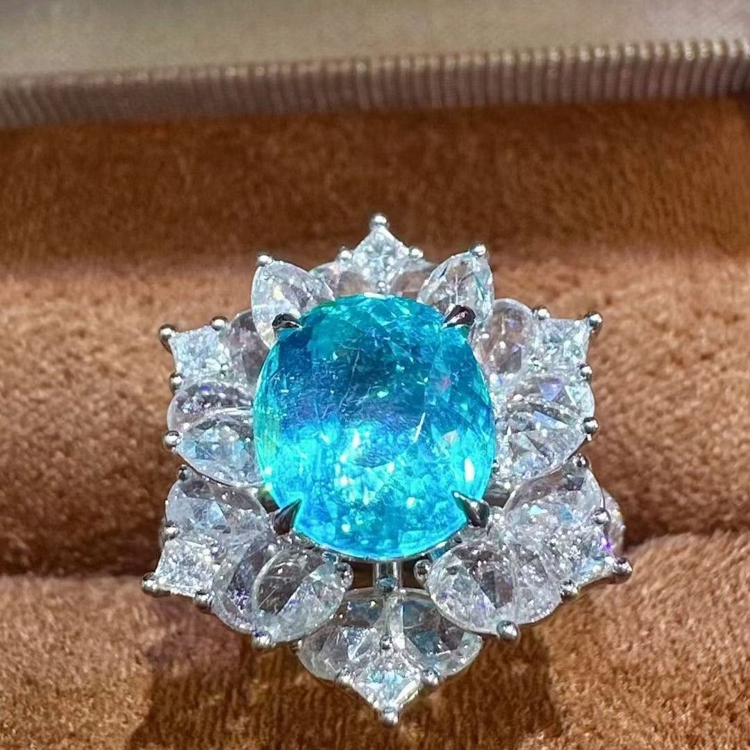 14k Gold 4.88 Ctw Natural Paraiba Tourmaline & Diamond Ring: Ref:231073121 // gold content:14k gold // ring size:7. 25us // // main gemstone:paraiba tourmaline // shape:oval // carat weight:3. 11ct // color:blue // treatment:natural // // adjacent gemstone 2 :