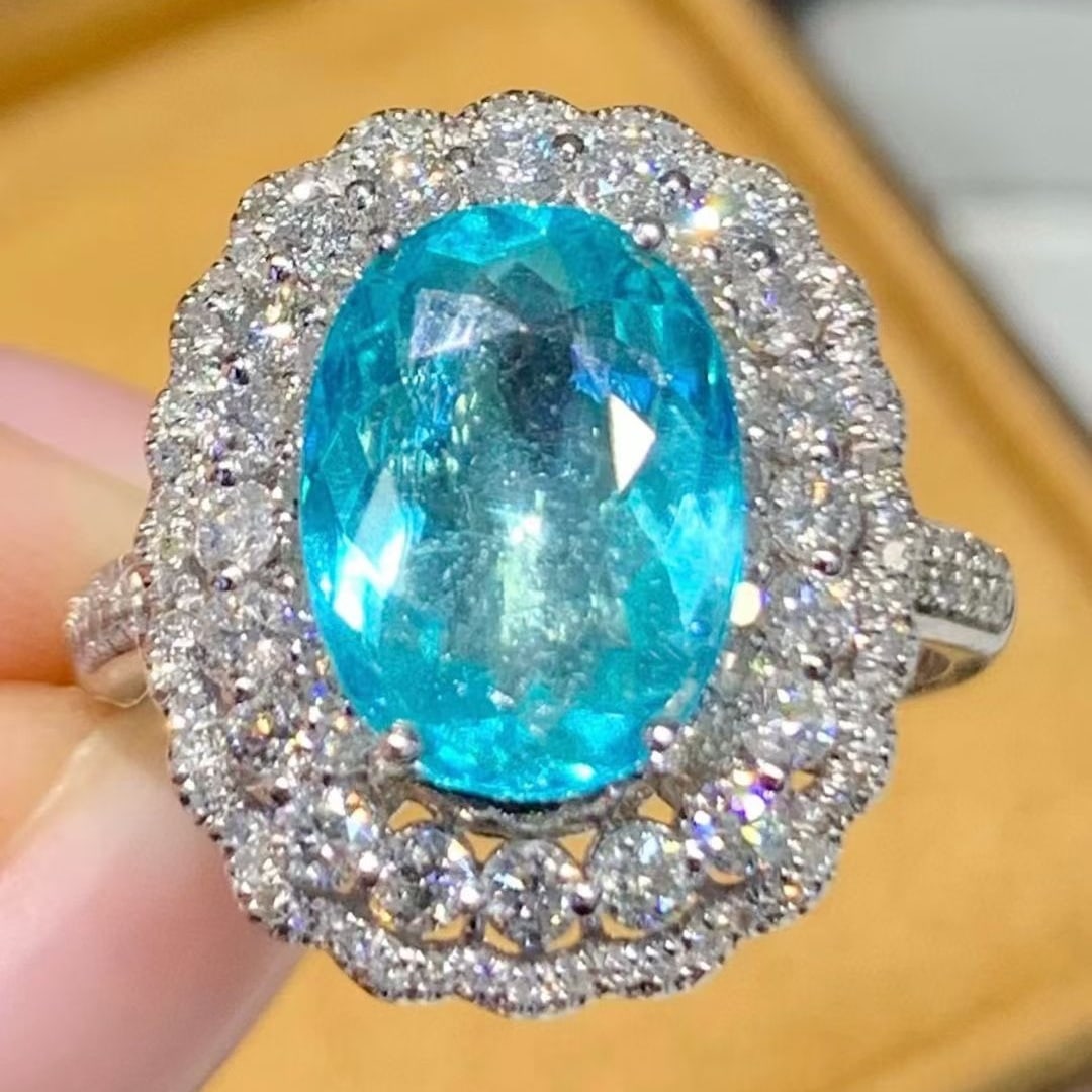 14k Gold 2.95 Ct Natural Paraiba Tourmaline & Diamond Ring: Ref:231083013 // gold content:14k gold // ring size:7. 25 us // // main gemstone:paraiba tourmaline // shape:oval // carat weight:2. 95ct // color:blue // treatment:natural // // adjacent gemstone 2
