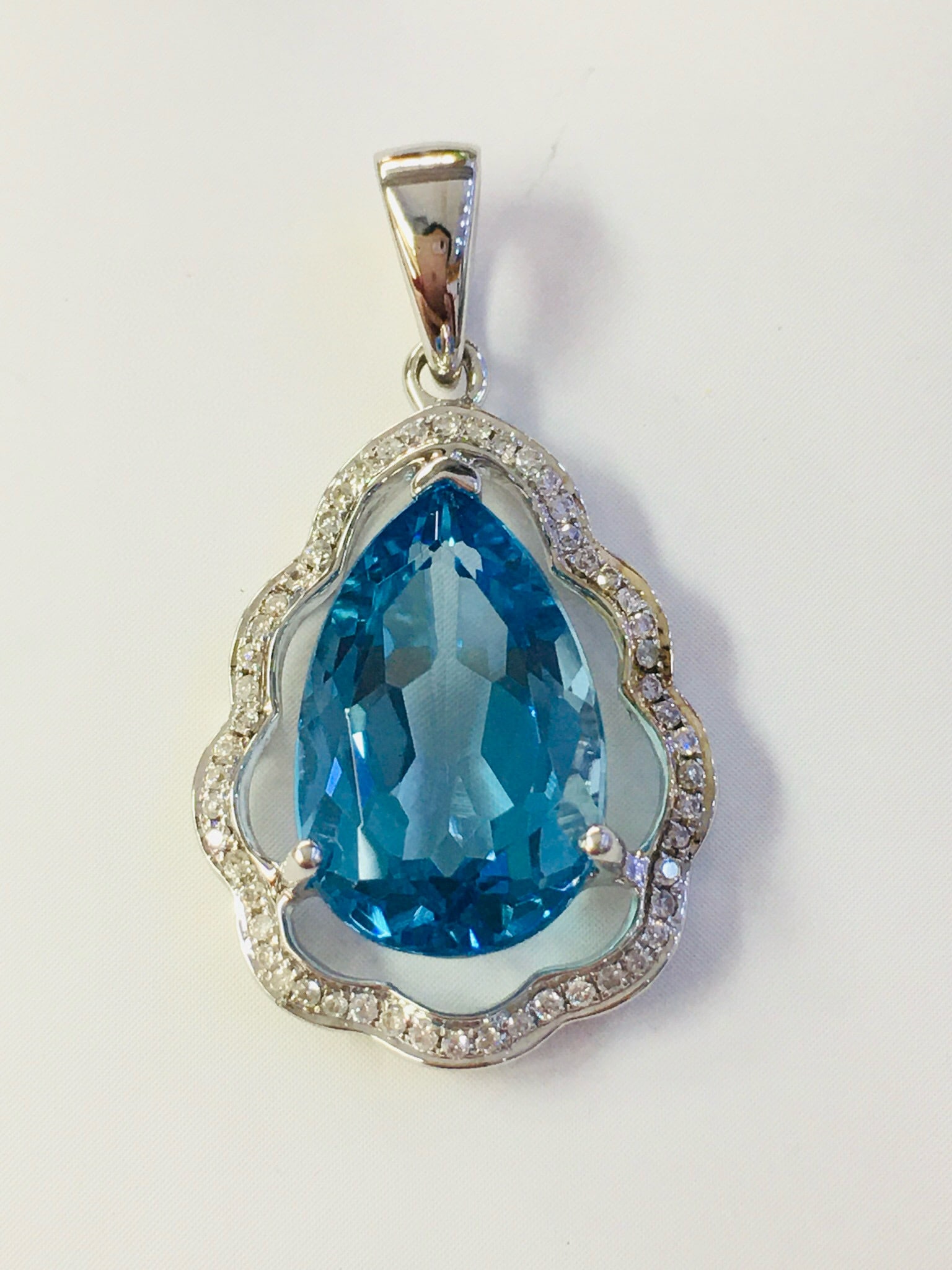 14k Gold 6.19 Ctw Natural Topaz & Diamond Pendant( Without Chain ): Ref:231082397 // gold content:14k gold // main gemstone:topaz // shape:pear // carat weight:6. 03ct // color:blue // treatment:natural // // adjacent gemstone 2 : diamond // number of stones:54 //