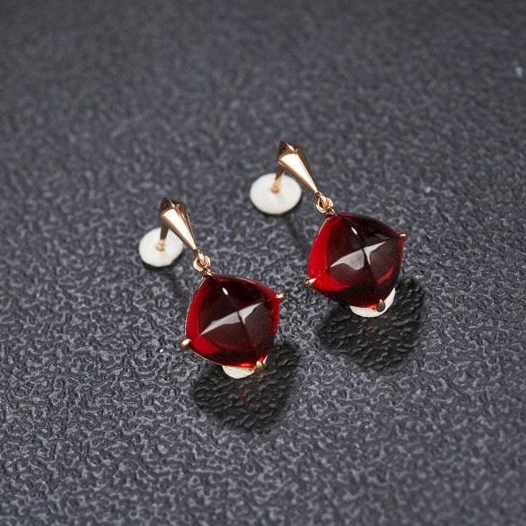 14k Gold 12.06 Ct Natural Garnet Earrings: Ref:231159251 // gold content:14k gold // main gemstone:garnet // shape:sugar-loaf // carat weight:12. 06ct // color:red // treatment:natural // Condition: New Low Estimate: 2200.00 High Estimate: