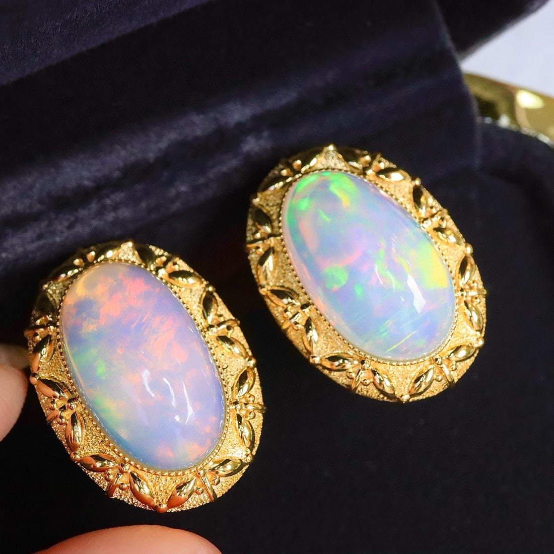 14k Gold 12.16 Ct Natural Opal Earrings: Ref:231160444 // gold content:14k gold // main gemstone:opal // shape:oval // carat weight:12. 16ct // color:color // treatment:natural // Condition: New Low Estimate: 9700.00 High Estimate: 15000.00
