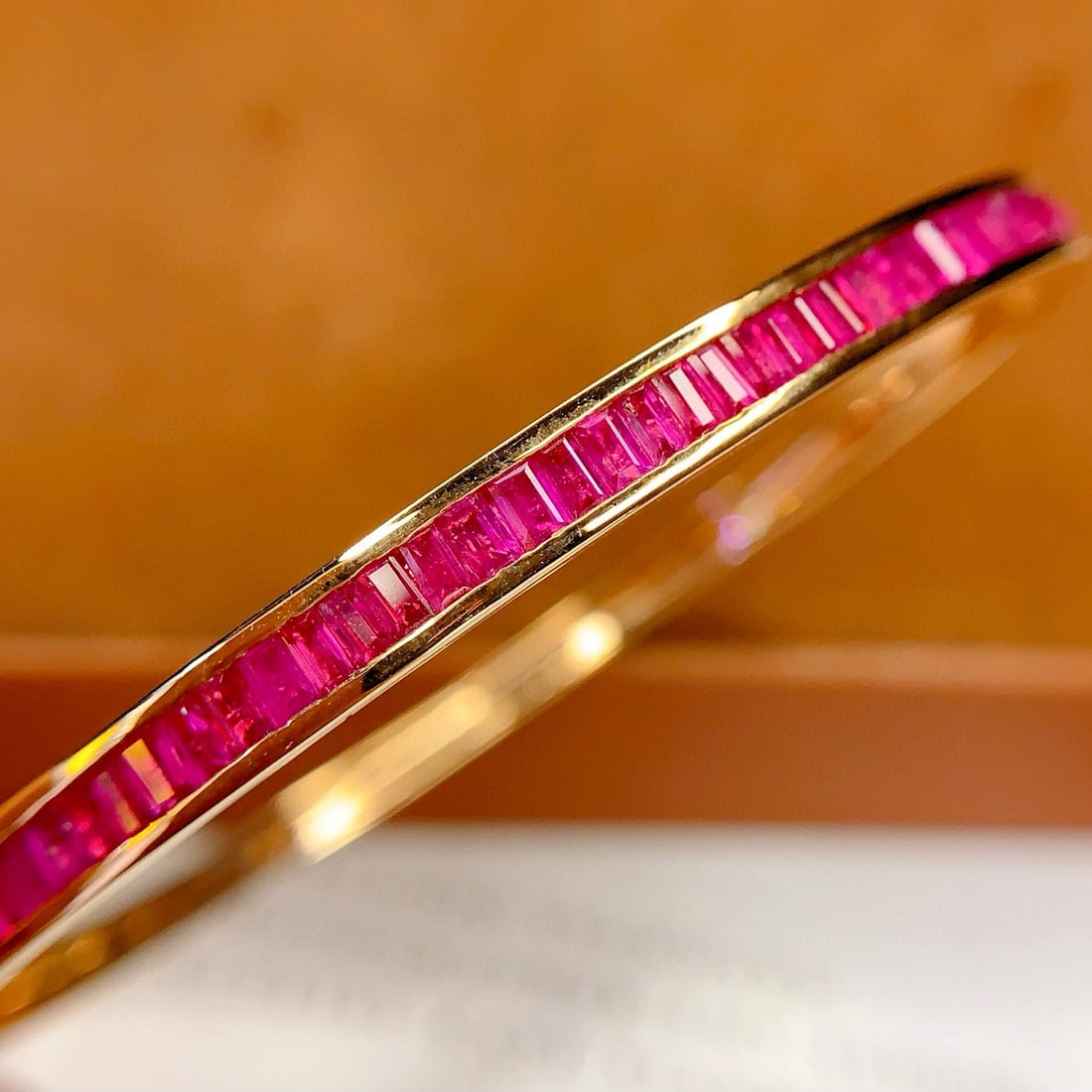14k Gold 4.68 Ct Natural Ruby Bangle: Ref:231078176 // gold content:14k gold // main gemstone:ruby // shape:rectangle // carat weight:4. 68ct // color:red // treatment:natural // Condition: New Low Estimate: 12000.00 High Estimate: