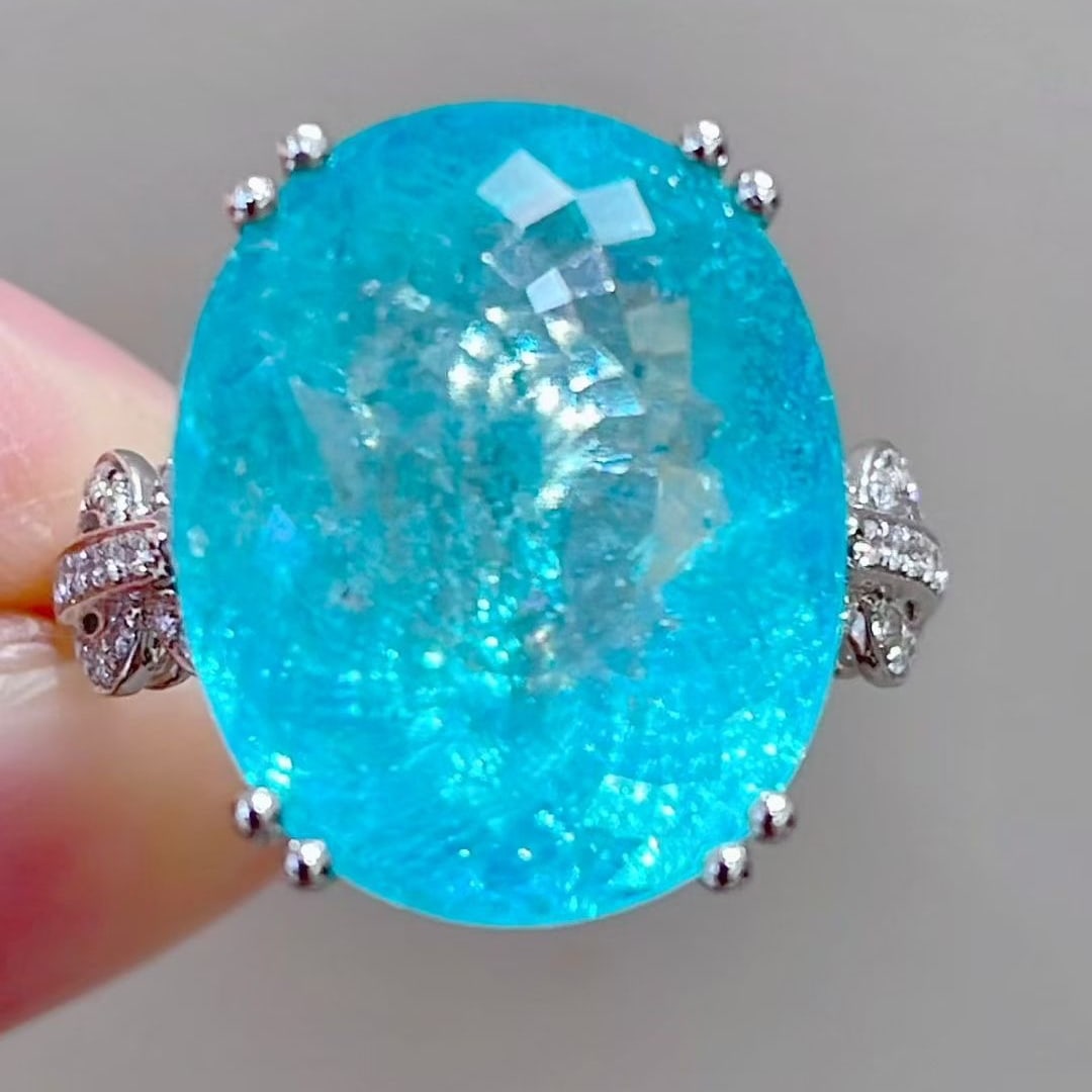 14k Gold 14.13 Ctw Natural Paraiba Tourmaline & Diamond Ring: Ref:231087085 // gold content:14k gold // ring size:7. 25 us // // main gemstone:paraiba tourmaline // shape:oval // carat weight:13. 78ct // color:blue // treatment:natural // // adjacent gemstone 2