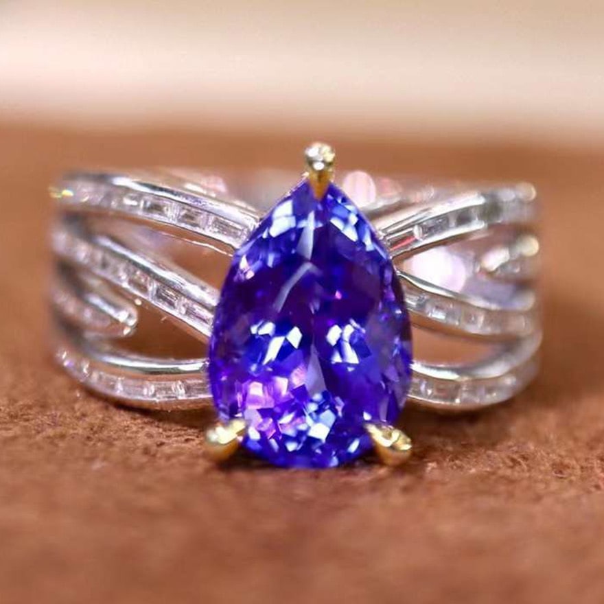 14k Gold 3.03 Ctw Natural Tanzanite & Diamond Ring: Ref:231091012 // gold content:14k gold // ring size:7. 25us // // main gemstone:tanzanite // shape:pear // carat weight:2. 60ct // color:blue // treatment:natural // // adjacent gemstone 2 : diamond