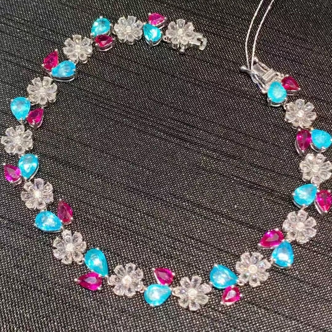 14k Gold 9.3 Ct Natural Paraiba Tourmaline & Ruby & Sapphire Bracelet: Ref:231091051 // gold content:14k gold // main gemstone:paraiba tourmaline & ruby // shape:pear // carat weight:9. 3ct // color:blue & red // treatment:natural // // adjacent gemstone 2 : sapphire //