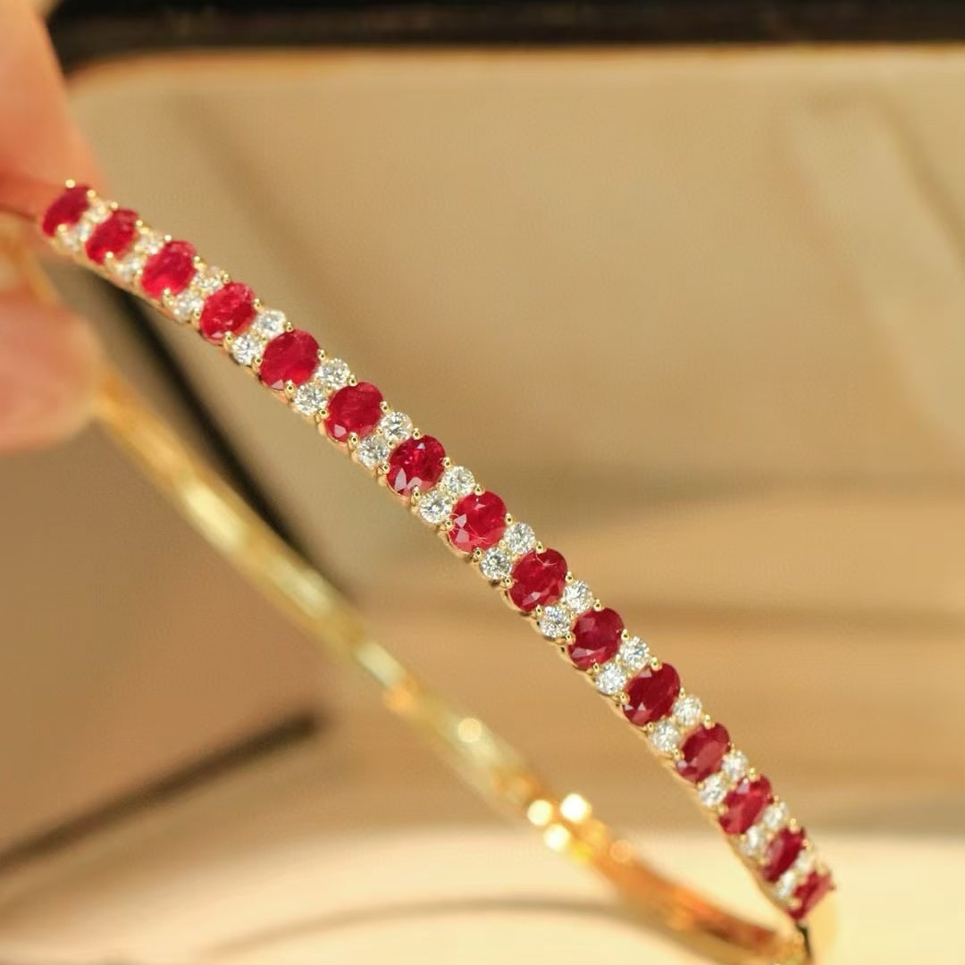 14k Gold 2.6 Ctw Natural Ruby & Diamond Bangle: Ref:231091196 // gold content:14k gold // main gemstone:ruby // shape:oval // carat weight:2. 1ct // color:red // treatment:natural // // adjacent gemstone 2 : diamond // shape:round // carat