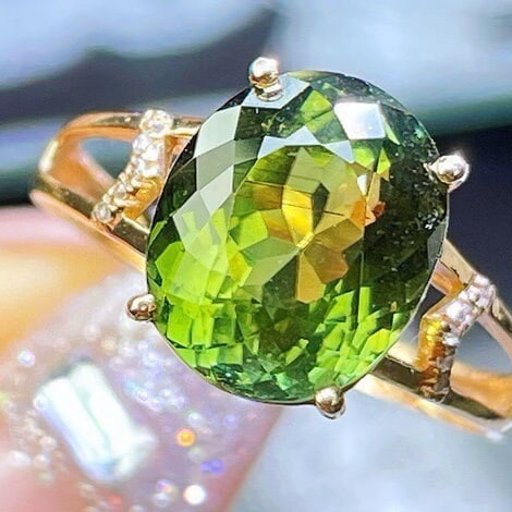 14k Gold 5.93 Ct Natural Tourmaline & Diamond Ring: Ref:231091204 // gold content:14k gold // ring size:7. 25us // // main gemstone:tourmaline // shape:oval // carat weight:5. 93ct // color:green // treatment:natural // // adjacent gemstone 2 : diamond