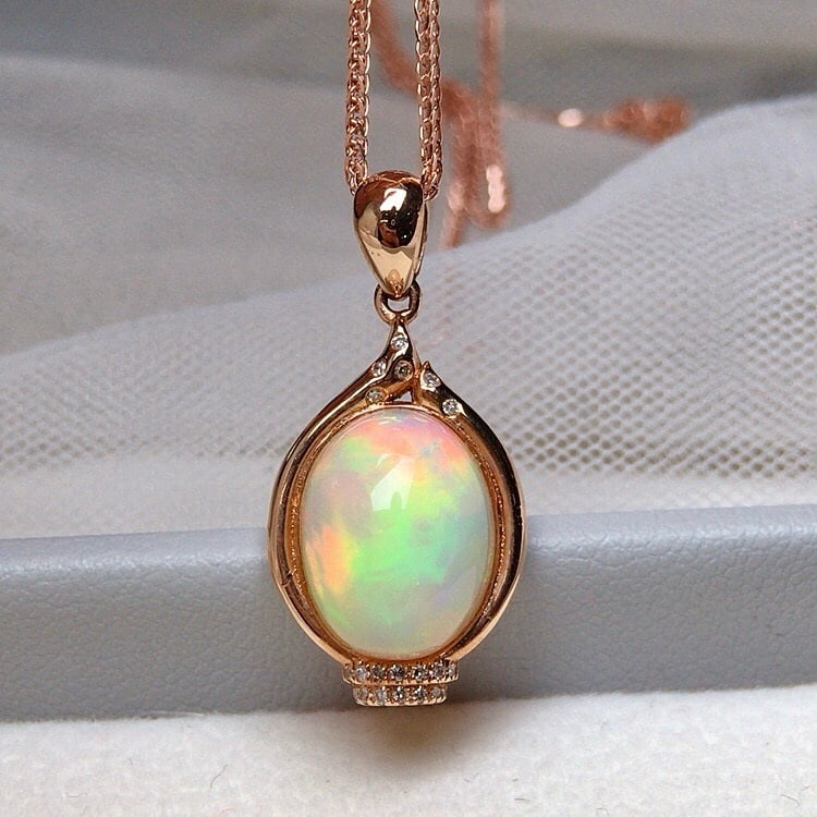 14k Gold 3.50 Ct Natural Opal & Diamond Pendant( Without Chain ): Ref:231093111 // gold content:14k gold // main gemstone:opal // shape:oval // carat weight:3. 50ct // color:color // treatment:natural // // adjacent gemstone 2 : diamond // number of stones:20 // sha