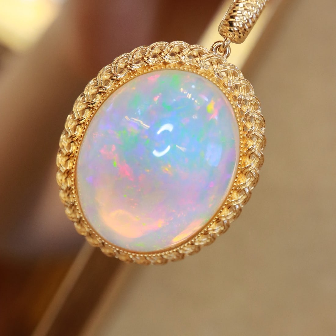 14k Gold 19.63 Ct Natural Opal Pendant( Without Chain ): Ref:231094061 // gold content:14k gold // main gemstone:opal // shape:oval // carat weight:19. 63ct // color:color // treatment:natural // Condition: New Low Estimate: 7500.00 High Estimate: 11000.00