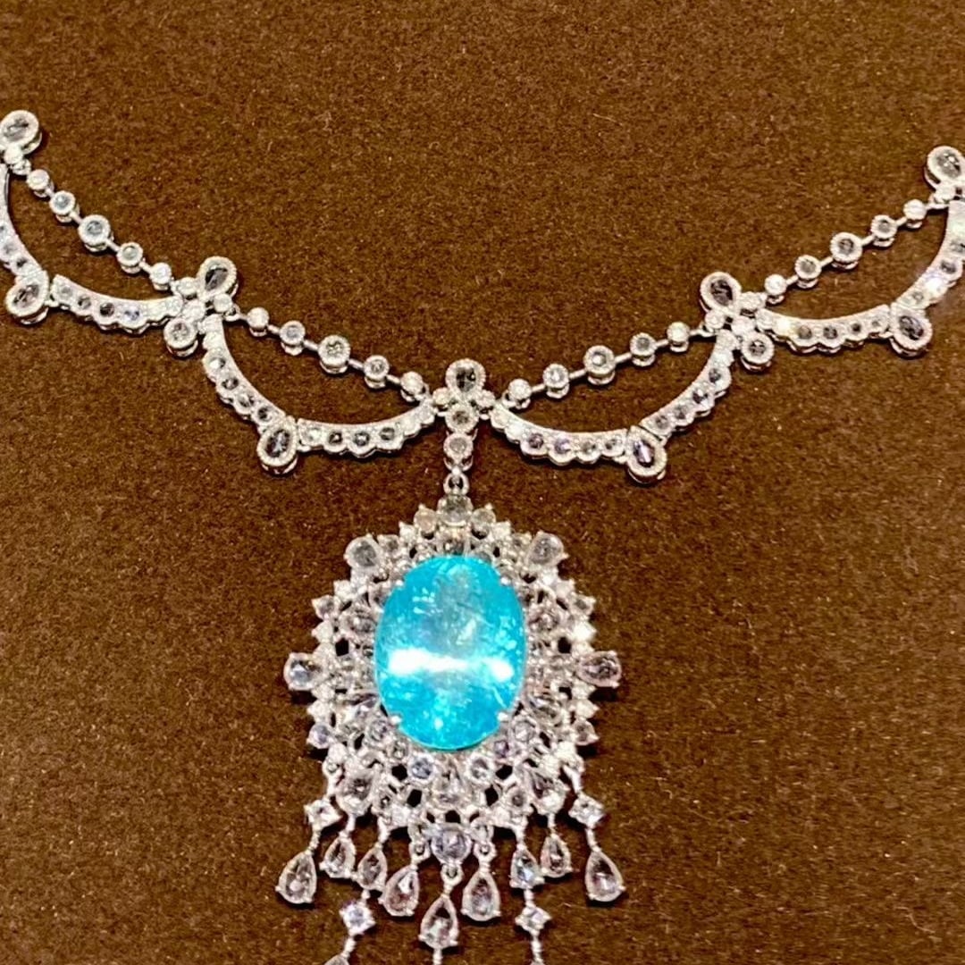 14k Gold 9.25 Ct Natural Paraiba Tourmaline & Diamond & Sapphire Necklace: Ref:231095011 // gold content:14k gold // main gemstone:paraiba tourmaline // shape:oval // carat weight:9. 25ct // color:neon blue // treatment:natural // // adjacent gemstone 2 : diamond //