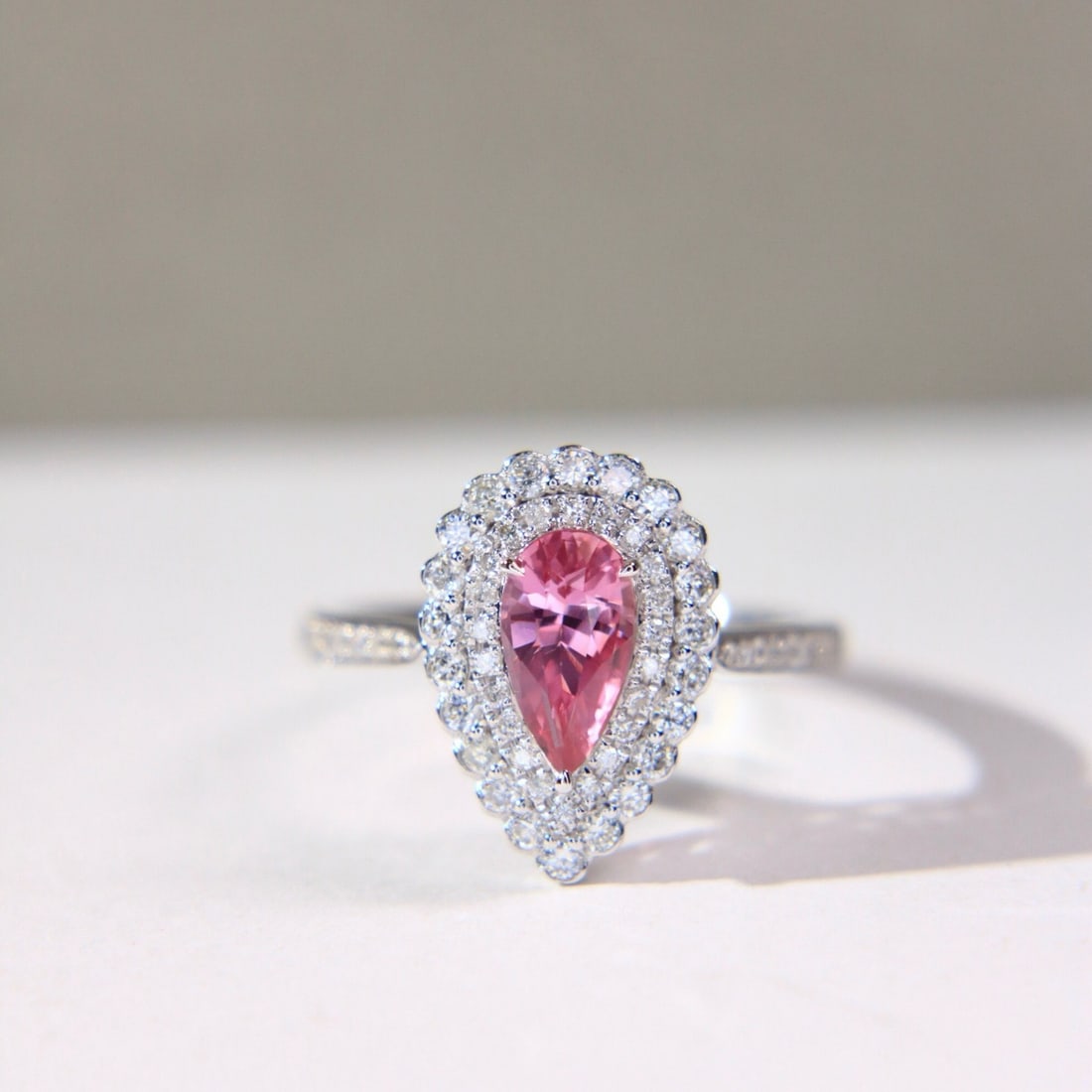 14k Gold 1.49 Ctw Natural Padparadscha Sapphire & Diamond Ring: Ref:231098001 // gold content:14k gold // ring size:7. 25us // // main gemstone:padparadscha sapphire // shape:pear // carat weight:1. 03ct // color:orangish pink // treatment:natural // // adjacent