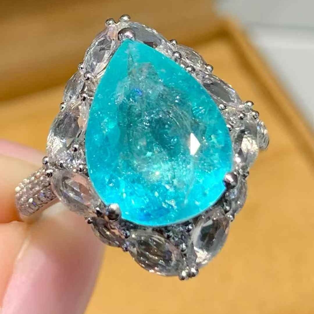 14k Gold 4.5 Ct Natural Paraiba Tourmaline & Diamond Ring: Ref:231103087 // gold content:14k gold // ring size:7. 25us // // main gemstone:paraiba tourmaline // shape:pear // carat weight:4. 5ct // color:blue // treatment:natural // // adjacent gemstone 2 : d