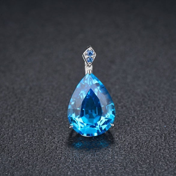 14k Gold 16.69 Ct Natural Topaz & Sapphire Pendant( Without Chain ): Ref:231106054 // gold content:14k gold // main gemstone:topaz // shape:pear // carat weight:16. 69ct // color:blue // treatment:natural // // adjacent gemstone 2 : sapphire // number of stones:2 // sh