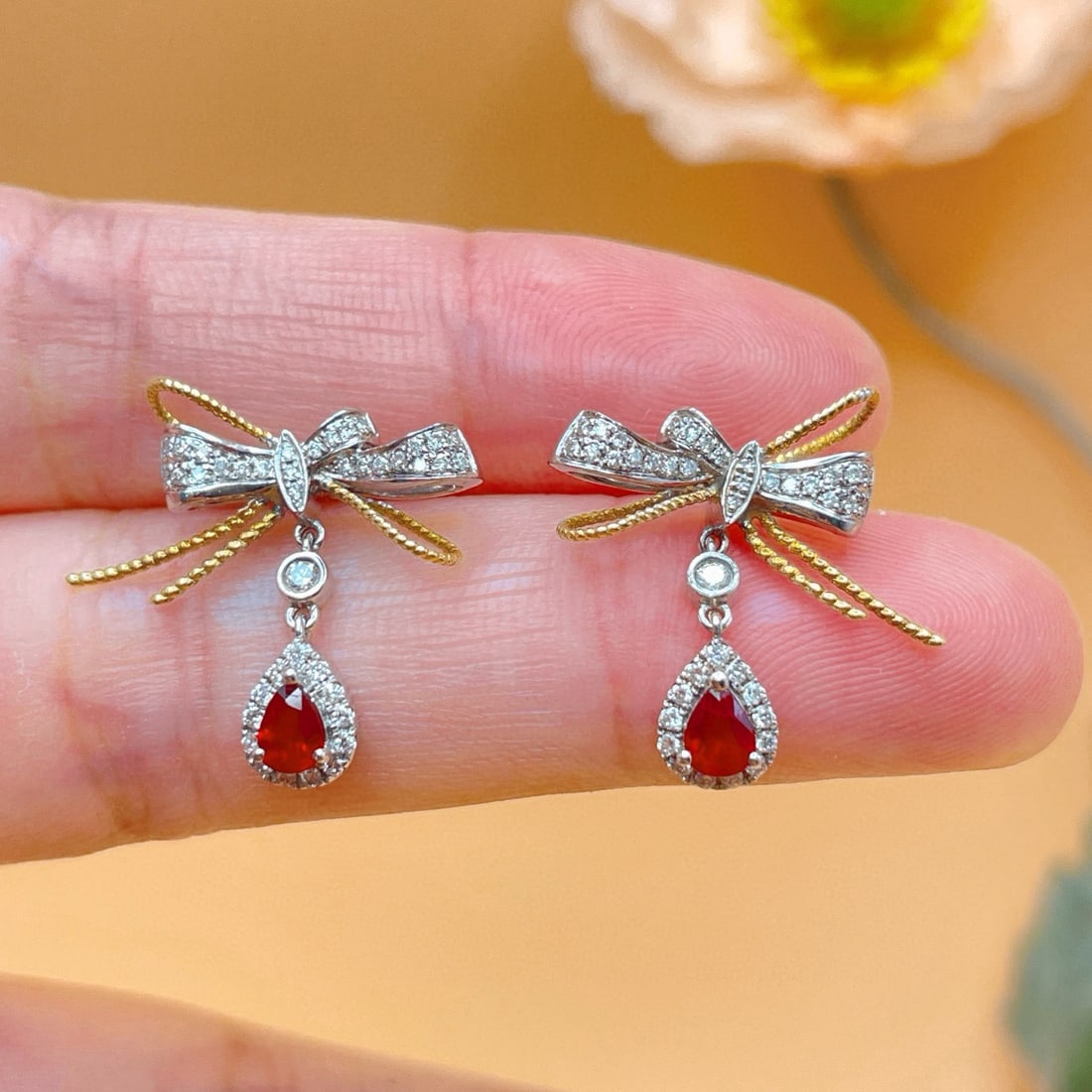 14k Gold 0.81 Ctw Natural Ruby & Diamond Earrings: Ref:231106220 // gold content:14k gold // main gemstone:ruby // shape:pear // carat weight:0. 43ct // color:red // treatment:natural // // adjacent gemstone 2 : diamond // shape:round // carat