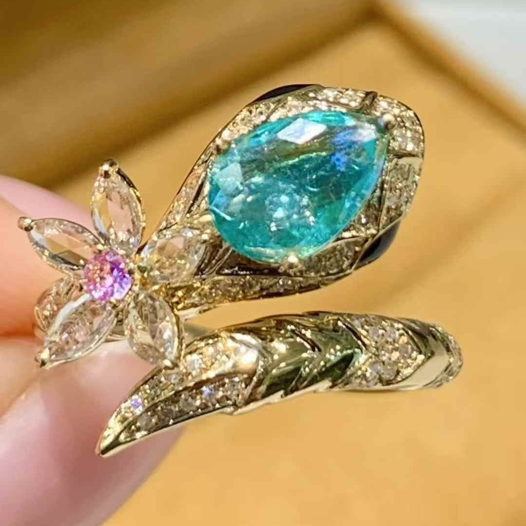 14k Gold 0.7 Ct Natural Paraiba Tourmaline & Diamond Ring: Ref:231107170 // gold content:14k gold // ring size:7. 25us // // main gemstone:paraiba tourmaline // shape:pear // carat weight:0. 7ct // color:blue // treatment:natural // // adjacent gemstone 2 :