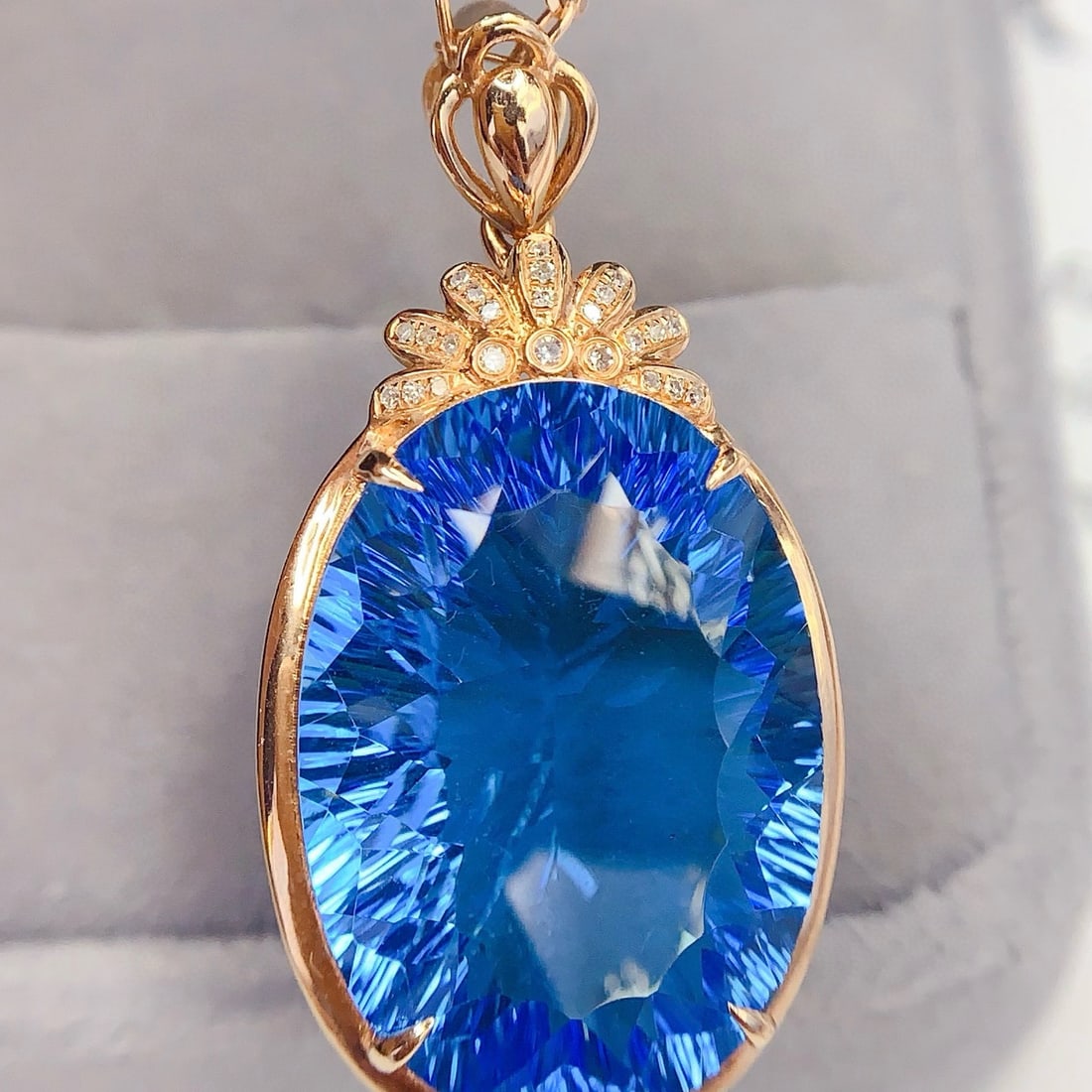 14k Gold 27 Ct Natural Topaz & Diamond Pendant( Without Chain ): Ref:231107211 // gold content:14k gold // main gemstone:topaz // shape:oval // carat weight:27ct // color:blue // treatment:natural // // adjacent gemstone 2 : diamond // number of stones:24 // shape: