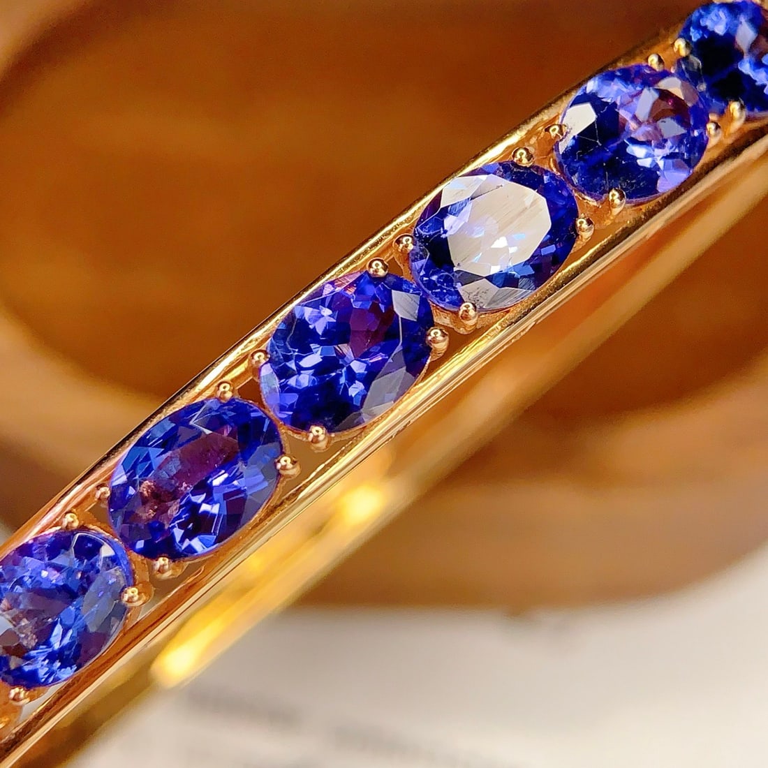 14k Gold 7.2 Ct Natural Tanzanite & Diamond Bangle: Ref:231108128 // gold content:14k gold // main gemstone:tanzanite // shape:oval // carat weight:7. 2ct // color:blue // treatment:natural // // adjacent gemstone 2 : diamond // number of stones:40 // 