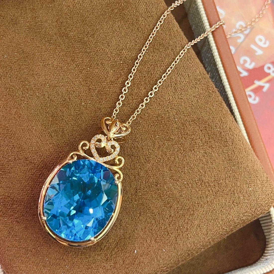 14k Gold 21.70 Ct Natural Topaz & Diamond Pendant( Without Chain ): Ref:231108272 // gold content:14k gold // main gemstone:topaz // shape:oval // carat weight:21. 70ct // color:blue // treatment:natural // // adjacent gemstone 2 : diamond // number of stones:18 //