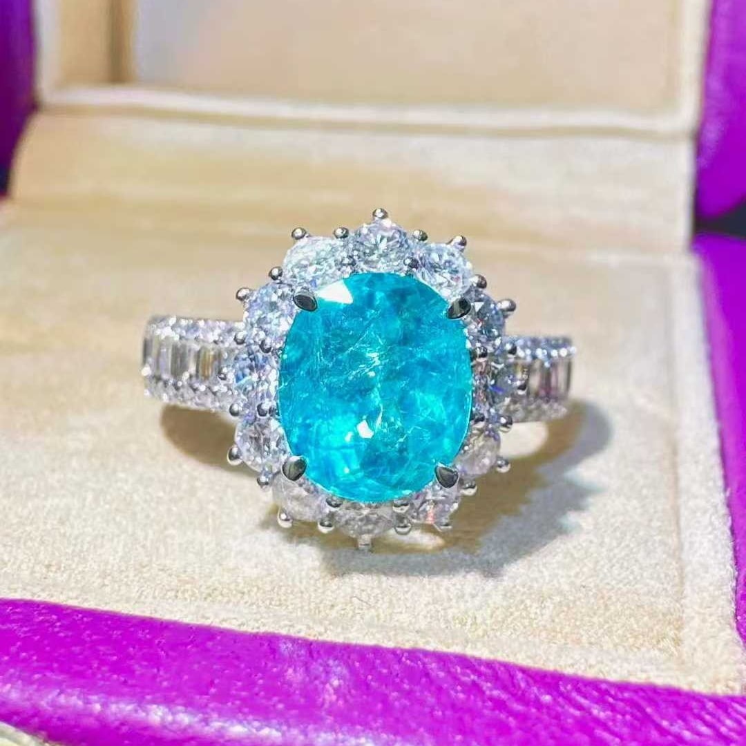 14k Gold 3.03 Ctw Natural Paraiba Tourmaline & Diamond Ring: Ref:231111179 // gold content:14k gold // ring size:7. 25us // // main gemstone:paraiba tourmaline // shape:oval // carat weight:2. 07ct // color:blue // treatment:natural // // adjacent gemstone 2 : 