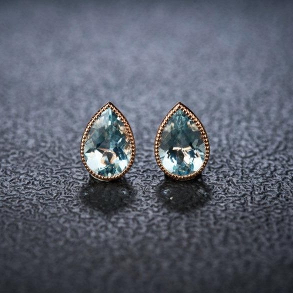 14k Gold 2 Ct Natural Aquamarine Earrings: Ref:231112007 // gold content:14k gold // main gemstone:aquamarine // shape:pear // carat weight:2ct // color:blue // treatment:natural // Condition: New High Estimate: 2500 Low Estimate: 1700