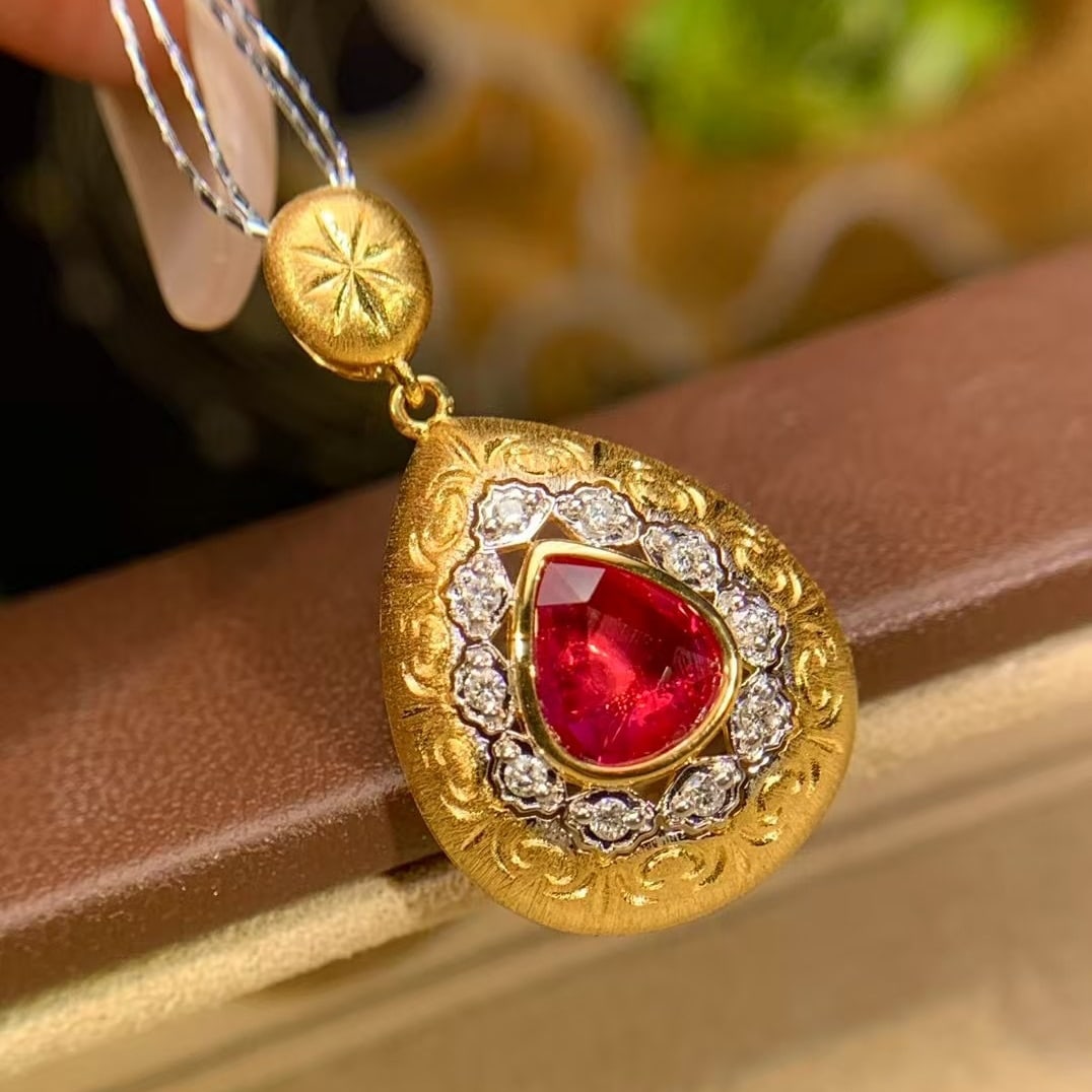 14k Gold 0.91 Ct Natural Ruby & Diamond Pendant( Without Chain ): Ref:231112173 // gold content:14k gold // main gemstone:ruby // shape:pear // carat weight:0. 91ct // color:red // treatment:natural // // adjacent gemstone 2 : diamond // number of stones:10 //