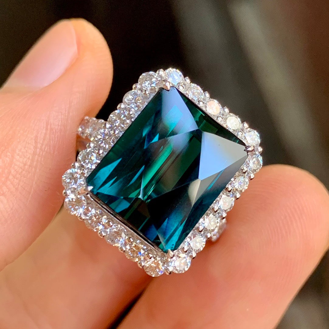 14k Gold 8.09 Ctw Natural Tourmaline & Diamond Ring: Ref:231112335 // gold content:14k gold // ring size:7. 25us // // main gemstone:tourmaline // shape:radiant // carat weight:6. 88ct // color:bluish green // treatment:natural // // adjacent gemstone 2