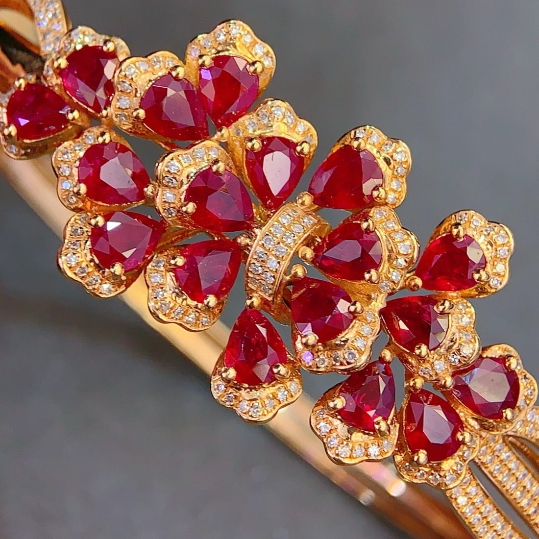 14k Gold 6.3 Ct Natural Ruby & Diamond Bangle: Ref:231112438 // gold content:14k gold // main gemstone:ruby // shape:pear // carat weight:6. 3ct // color:red // treatment:natural // // adjacent gemstone 2 : diamond // number of stones:260 //