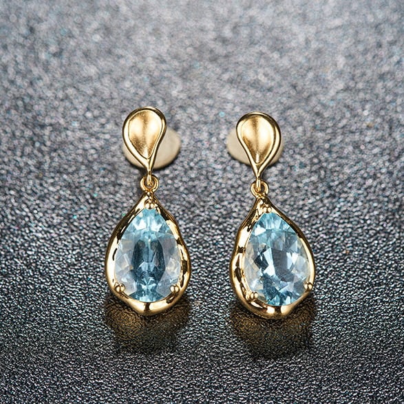 14k Gold 3.42 Ct Natural Aquamarine Earrings: Ref:231109137 // gold content:14k gold // main gemstone:aquamarine // shape:pear // carat weight:3. 42ct // color:santa maria color // treatment:natural // Condition: New High Estimate: 5000 Low