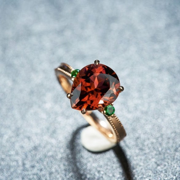 14k Gold 3.52 Ct Natural Tourmaline & Tsavorite Ring: Ref:231113095 // gold content:14k gold // ring size:7. 25us // // main gemstone:tourmaline // shape:pear // carat weight:3. 52ct // color:orangish red // treatment:natural // // adjacent gemstone 2 :