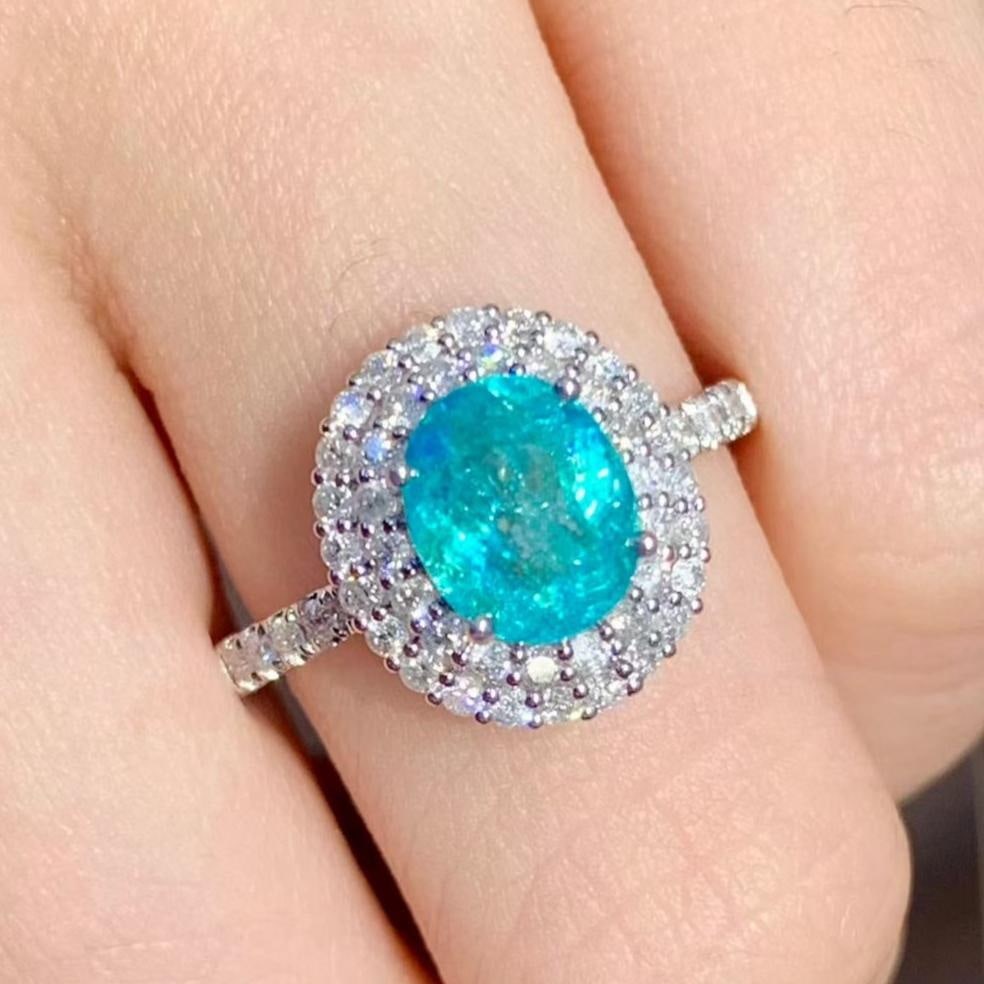 14k Gold 1.5 Ct Natural Paraiba Tourmaline & Diamond Ring: Ref:231113133 // gold content:14k gold // ring size:7. 25us // // main gemstone:paraiba tourmaline // shape:oval // carat weight:1. 5ct // color:blue // treatment:natural // // adjacent gemstone 2 :