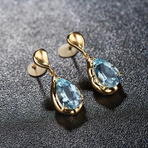 14k Gold 3.42 Ct Natural Aquamarine Earrings: Ref:231114003 // gold content:14k gold // main gemstone:aquamarine // shape:pear // carat weight:3. 42ct // color:santa maria color // treatment:natural // Condition: New Low Estimate: 3700.00 High